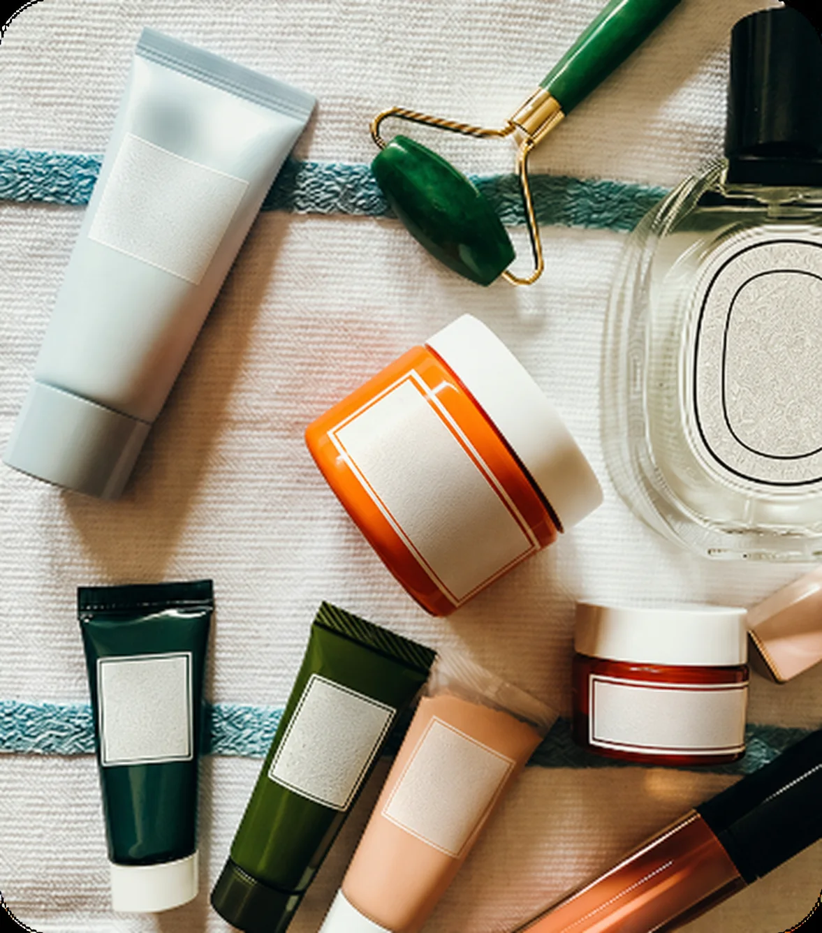 Assorted unbranded skincare products on a towel